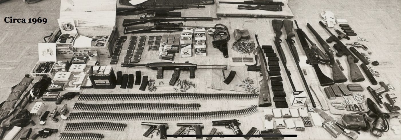 Confiscated weapons and ammunition laid out, circa 1969