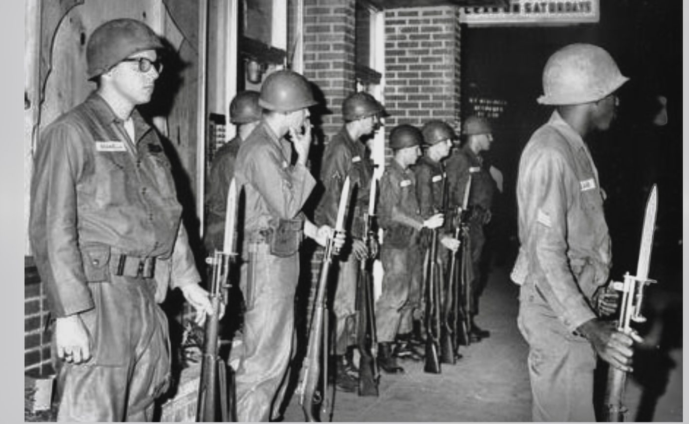 National Guardsmen with fixed bayonets posted at storefronts