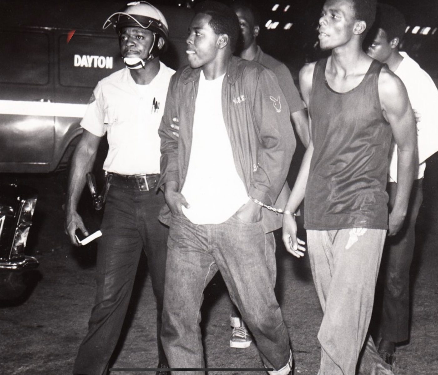Night arrests beside a Dayton police wagon